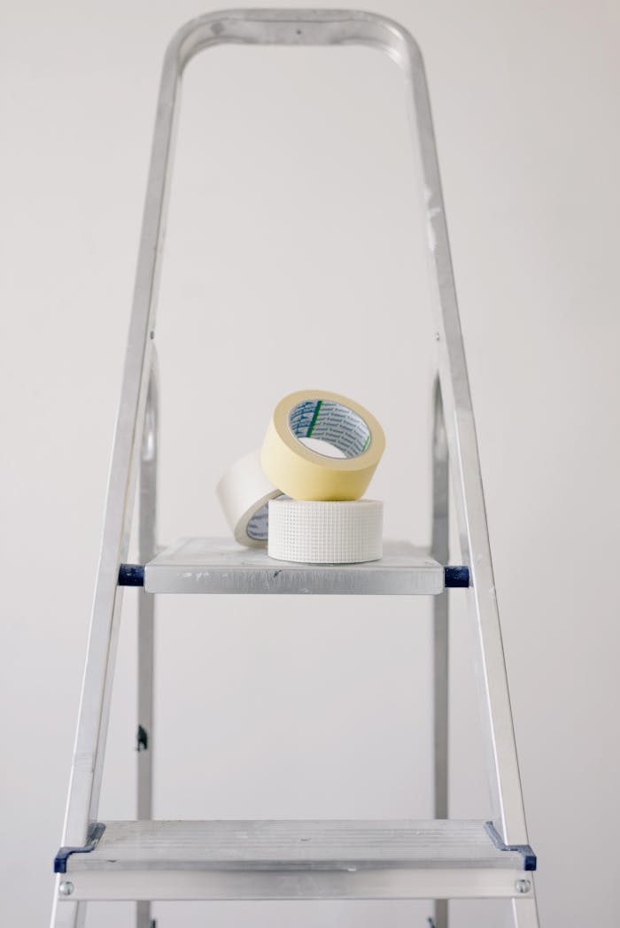 Crafting Captivating Headlines: Your awesome post title goes here Metal stepladder with rolls of tape for home renovation projects.